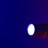 Citronic PAR60-RGB 60W LED profile spotlight by AVSL shown lit with a bright white beam against a deep blue background.