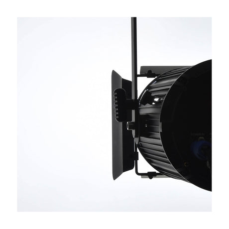 Side view of the Citronic MFZ100-W mini Fresnel LED stage light by AVSL in matte black, with barn doors and mounting bracket, on a white background.