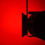 Citronic MFZ160-RGBW mini Fresnel zoom LED stage light shown from the side with barn doors, lit red against a red background.