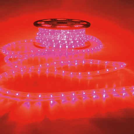 LYYT 230V IP44 50m LED rope light in red, partly unspooled from a reel with illuminated coils trailing across a red-lit surface.