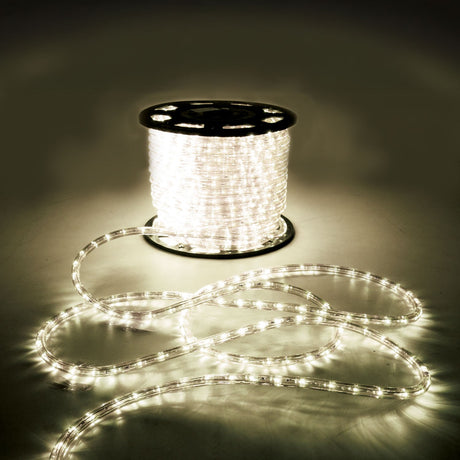 LYYT 50m LED rope light reel by AVSL, illuminated warm white 2800K, with clear flexible tubing coiled on the floor in a dim setting.