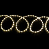 LYYT 50m LED rope light coiled in illuminated loops emitting warm white 2800K glow against a black background.