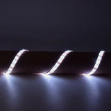 LYYT 5m RGB LED strip kit by AVSL draped over a cylindrical surface in a dim setting, showing three illuminated sections glowing cool white.