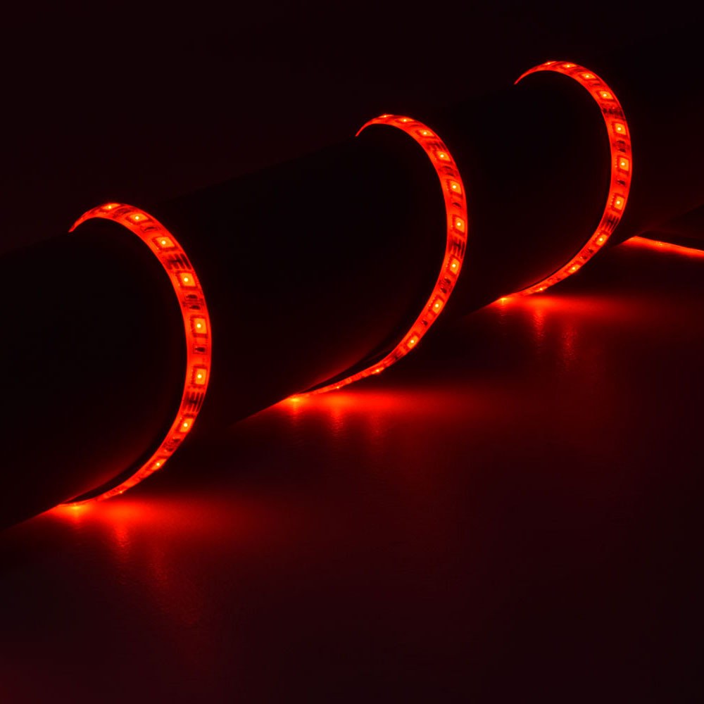AVSL LYYT 5m RGB LED strip kit coiled and illuminated in red, showing the IP68 silicone tape with evenly spaced SMD LEDs glowing along its length.