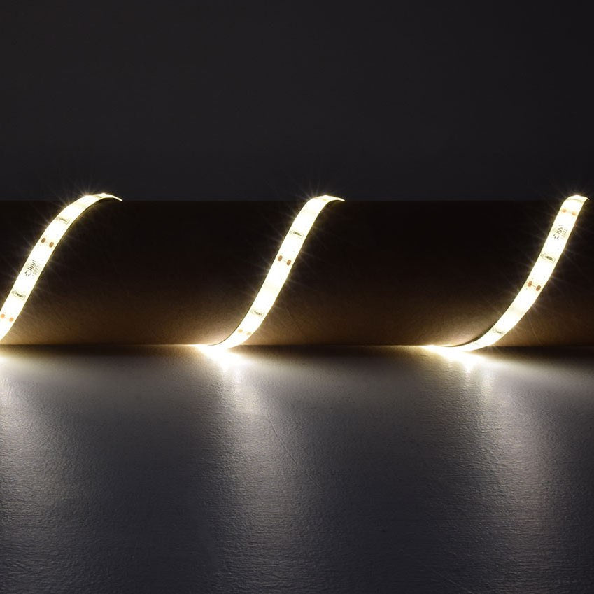 LYYT 12V LED strip light kit by AVSL installed in a wave pattern, emitting warm white 3000K glow against a dark grey background.