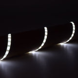 LYYT 12V LED strip light draped in curves, illuminated in cool white 6000K, showing flexible IP65 silicone tape with visible SMD LEDs against a dark surface.