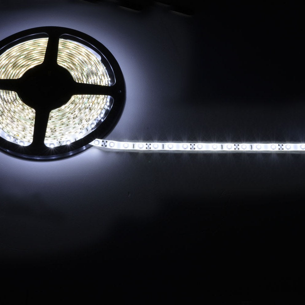 LYYT 5m LED strip light kit by AVSL illuminated in cool white 6000K, shown partly unspooled from its reel against a dark background.