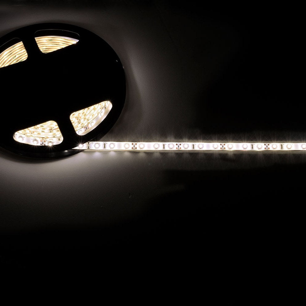 LYYT 12V LED strip light kit by AVSL shown partially unspooled from its black reel, emitting bright warm white light along the IP65 silicone-coated tape.