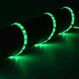 LYYT 12V LED Strip Light by AVSL wrapped around a dark pipe, glowing vivid green along the flexible IP65 tape with light spill on the surface.