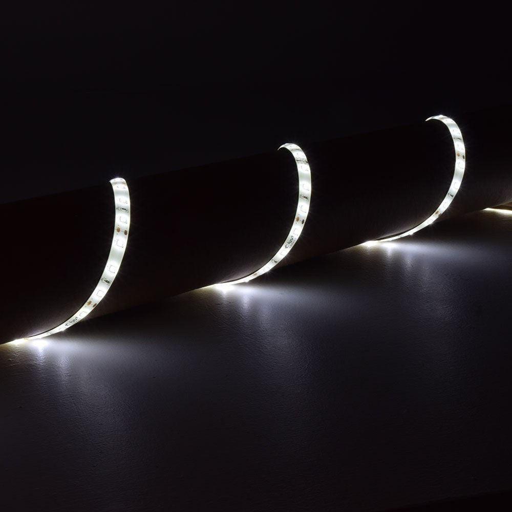 LYYT DIY-DW120 waterproof LED strip by AVSL, 5m flexible tape coiled along a dark surface and illuminated in cool white.