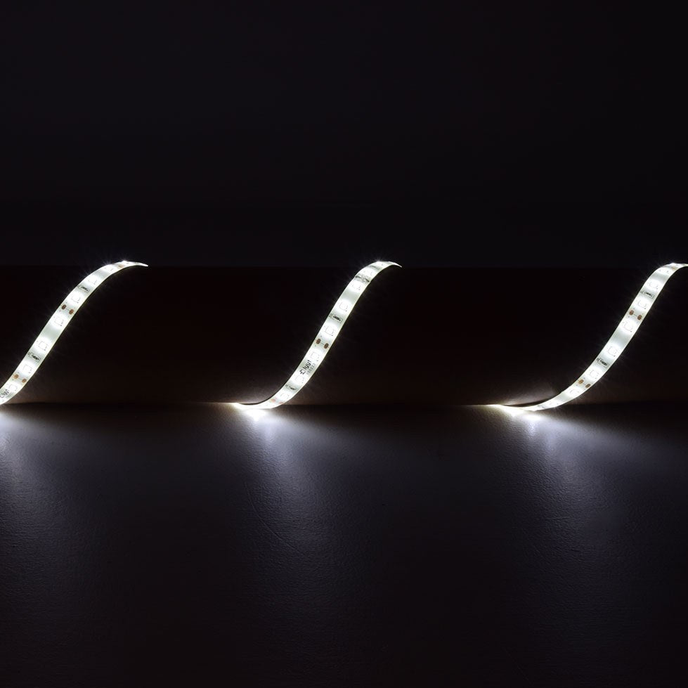 LYYT DIY-DW120 waterproof LED strip by AVSL, 5m flexible tape illuminated in cool white and arranged in a wave across a dark surface.