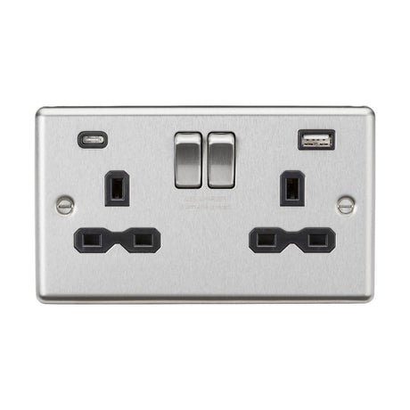 A brushed chrome double electrical wall socket, featuring a sleek rounded edge design, comes with dual USB A+C charger ports and two switches.