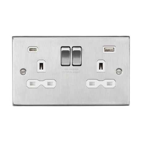 A brushed chrome 13A 2 Gang SP switched socket with a dual USB A+C charger, featuring two standard electrical outlets and centrally located switches. The white insert and sleek square edge design offer a modern touch for efficient charging and power access.