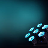 Citronic CosmoPAR PAR light by AVSL with seven glowing cyan RGBW COB LEDs in white housing, angled against a dark teal background.