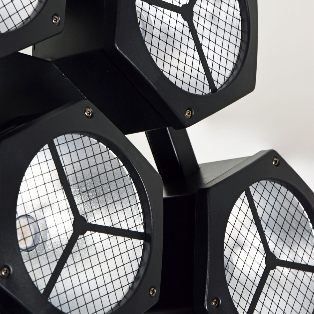 Close-up of the Citronic CosmoPAR RGBW COB LED PAR light by AVSL, showing matte black hexagonal heads with mesh-covered snowflake-style lens faces.