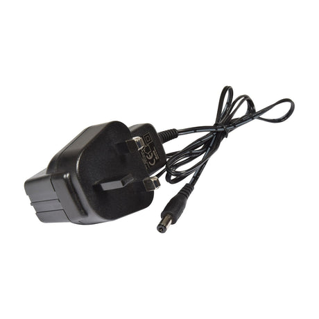 Included 12Vdc 1000mA UK plug power adapter for the QTX 192 Channel DMX Lighting Controller by AVSL, with coiled black DC output cable on a white background.