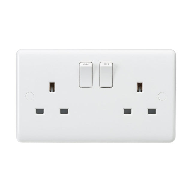 A 13A 2 Gang DP Switched Socket With Twin Earths - ASTA Approved (Rounded Edge) is displayed, certified to BS 1363-2:2016+A1:2018. It features two switches in the on position against a plain background, has two plug slots per side, and boasts anti-microbial properties for added safety.