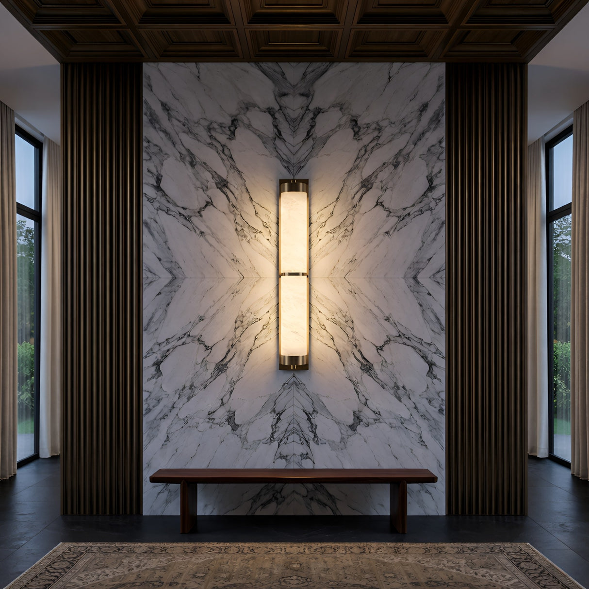 A symmetrical modern interior features a marble accent wall, vertical wooden panels, and a central Arelis LED Linear Alabaster Wall Light in Soft White & Brushed Brass. A simple bench sits below large windows, with part of a rug visible on the floor.