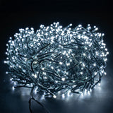 LYYT 960 LED outdoor string lights by AVSL, coiled dark green cable densely packed with cool white LEDs illuminated against a black background.
