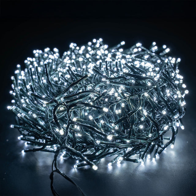 LYYT 960 LED outdoor string lights by AVSL, coiled dark green cable densely packed with cool white LEDs illuminated against a black background.