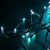 LYYT 960 LED cluster string lights by AVSL glowing in cool white and blue along a dark green cable coiled on a dark surface.