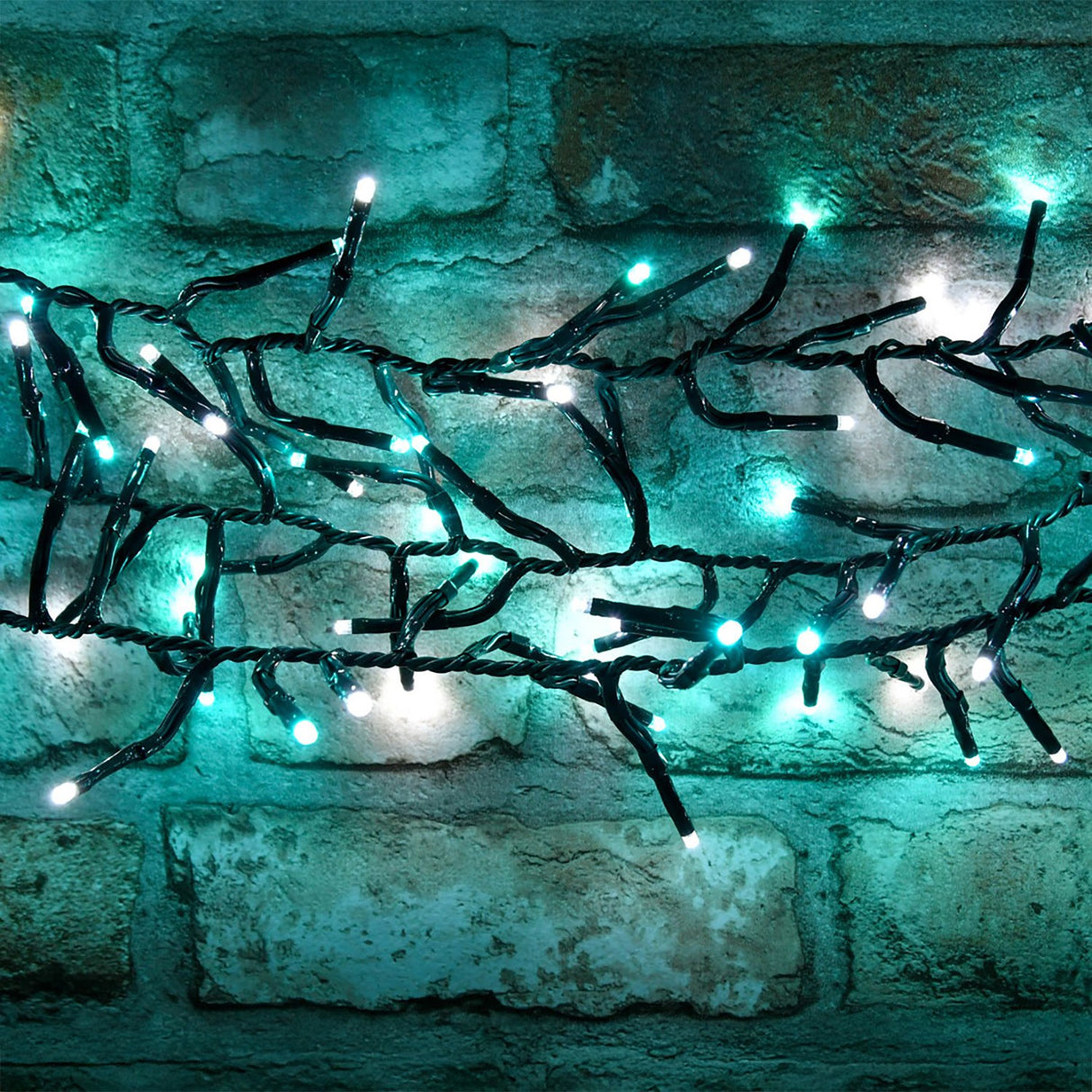 LYYT 960 LED cluster string lights in cool white and blue on a dark green cable, draped across a rustic brick wall.