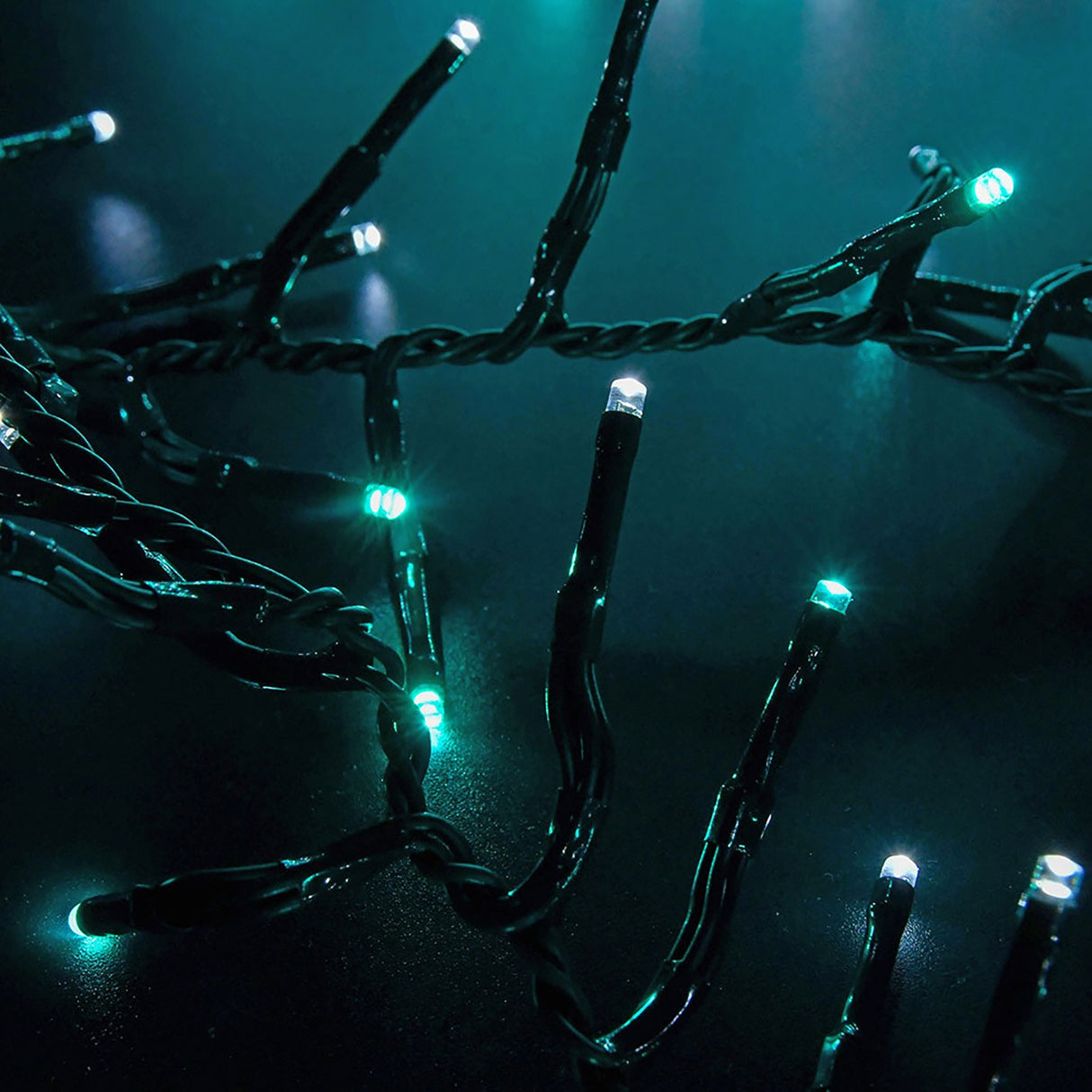 LYYT 960 LED cluster string lights by AVSL shown close-up with dark green cable and densely spaced cool white and blue LEDs glowing against a dark background.