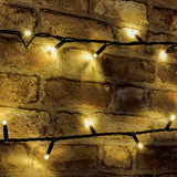 LYYT 180 LED heavy duty string light in warm white, shown lit against an exposed brick wall with concave LEDs on a black rubber cable.