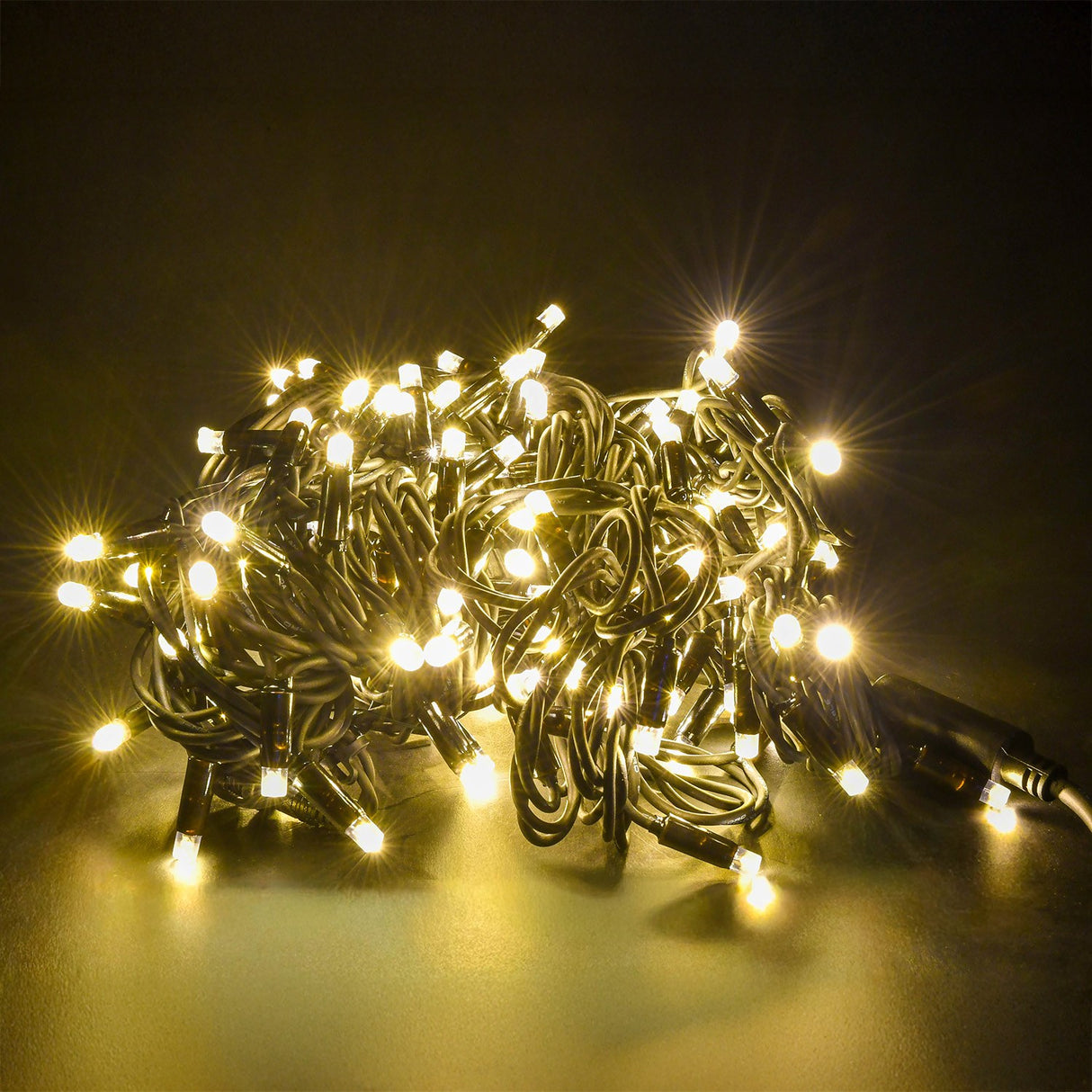 LYYT 180 LED heavy duty string light coiled and illuminated, showing warm white concave LEDs along a black rubber cable with inline connector.