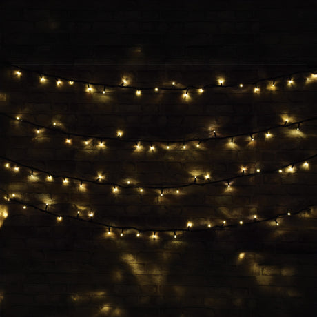 The LYYT 180 LED Heavy Duty LED String Lights with Controller, featuring warm white bulbs, are displayed in three rows against a brick wall, offering a cozy and ambient atmosphere. Ideal for outdoor use, they provide energy efficiency, combining charm with eco-friendliness over their 20-meter length.