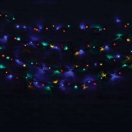 A strand of vibrant Christmas lights, specifically the LYYT 90 LED Heavy Duty LED String Lights With Controller, 11m - RGBA, brightens the dark. The red, green, blue, and amber bulbs produce a festive ambiance as they drape gracefully against the night sky.