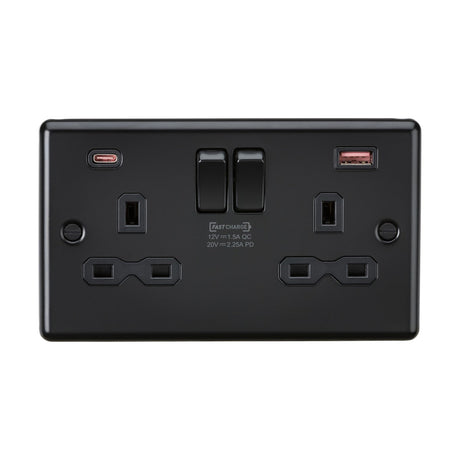 A sleek and modern wall outlet, the 13A 2 Gang DP Switched Socket With Dual USB A+C, comes in a stylish matt black finish with black inserts and a rounded edge design. It features two standard sockets, dual switches, and strategically placed FASTCHARGE USB A+C ports in the upper corners for convenience.