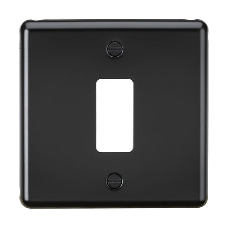 The 1 Gang Grid Faceplate in matt black is a chic rectangular wall plate with a single toggle switch cutout. It boasts smooth edges and includes two visible screws for mounting, adding a stylish element to any room.