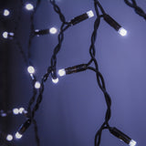 Close-up of LYYT 100CONI-CW cool white LED icicle string lights by AVSL with 5mm concave bulbs on twisted black rubber cable against a dark backdrop.