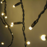 Close-up of LYYT 100CONI-WW warm white icicle string lights with lit LEDs on twisted black cable at varying drop lengths.