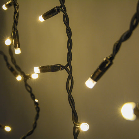 Close-up of LYYT 100CONI-WW warm white icicle string lights with lit LEDs on twisted black cable at varying drop lengths.