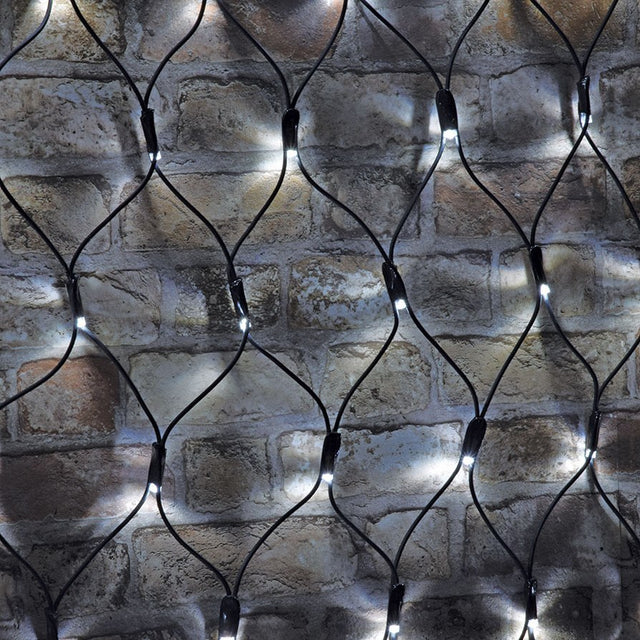 AVSL LYYT 144NET-CW cool white connectable net light with black rubber cable mesh and evenly spaced LEDs draped over a rustic brick wall.