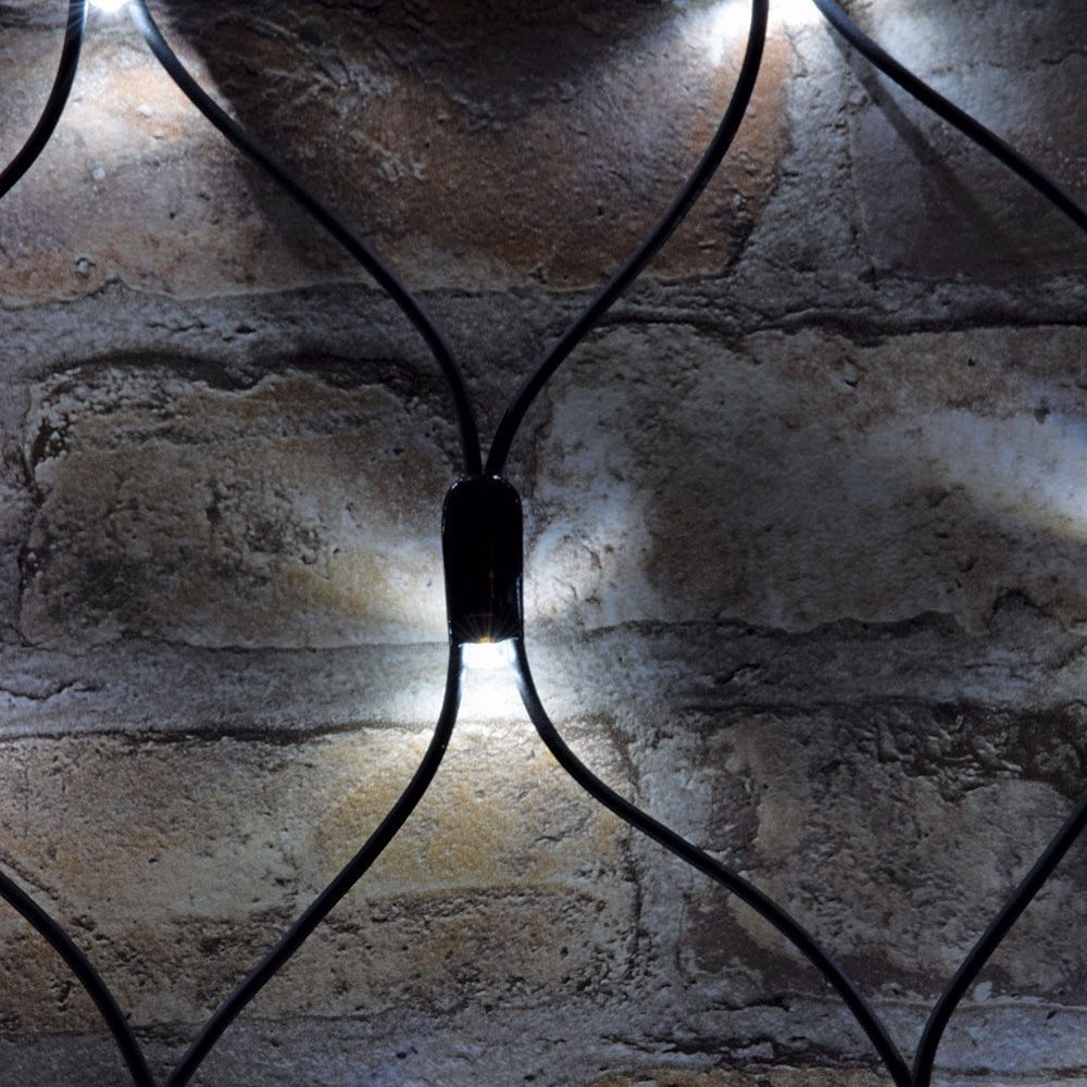 Close-up of AVSL LYYT 144NET-CW Cool White Connectable Net Light showing black rubber mesh cable and one lit concave LED head against a brick wall.