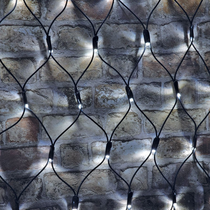 AVSL LYYT 144NET-CW cool white net light with 144 LEDs on a black rubber diamond-mesh cable draped over an exposed brick wall.