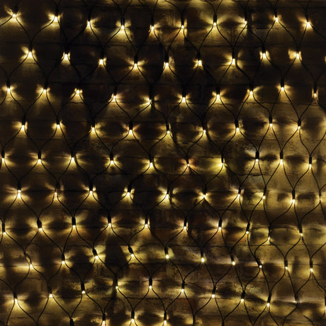 A close-up of a dark brown wall adorned with the LYYT 144 LED Outdoor Connectable Net Light, 1.2m in warm white, forming a cozy and glowing pattern. These energy-efficient net lights emit a gentle illumination across the textured surface.