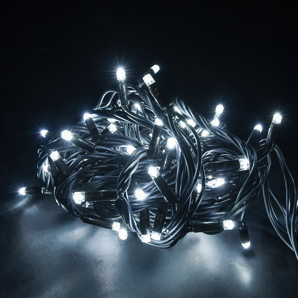 LYYT heavy duty festoon string lights coiled and illuminated in cool white, showing concave LED heads along a black UV-resistant rubber cable.