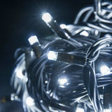 Close-up of LYYT HD90C-WHT Cool White Heavy Duty Festoon Lights by AVSL, showing illuminated concave LEDs along a coiled black rubber cable at night.