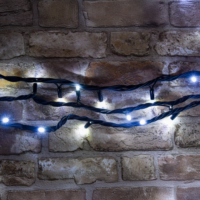 LYYT cool white connectable festoon lights with 10-plus LEDs on black rubber cable, draped in coils against an exposed brick wall.