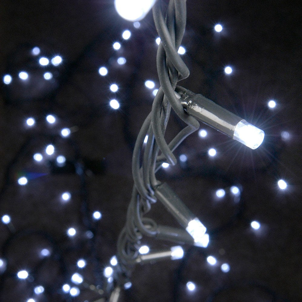 Close-up of LYYT HD180C-WHT cool white festoon string lights by AVSL, showing illuminated LEDs on black rubber cable against a dark background.