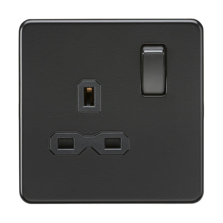 Introducing the 13A 1 Gang DP Switched Socket in a stylish matt black finish with a black insert, this screwless flat plate socket is designed with a UK plug layout. It features three rectangular prong slots and an elegantly placed switch on the upper right corner, offering both style and functionality in one seamless unit.