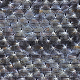 LYYT 240 LED cool white net light draped across an exposed brick wall, showing the 2m x 2m black cable mesh with evenly spaced lit LEDs.
