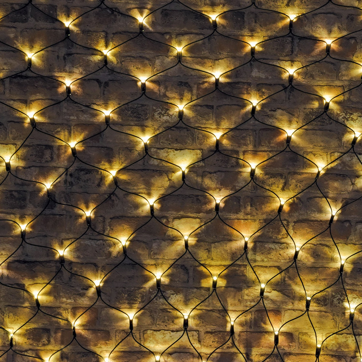 LYYT 240 LED net light with warm white bulbs on a black cable grid, draped across an exposed brick wall for outdoor decorative coverage.