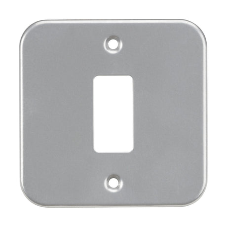 The Metalclad 1 Gang Grid Faceplate is a premium grade steel light switch cover, powder-coated in silver/grey. It features screw holes at the top and bottom, with a central rectangular opening for the toggle and rounded corners, offering a sleek design.