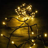 LYYT 120 LED Battery Topiary Ball Light shown lit in warm white, with black cable coiled and trailing across a dark surface at night.