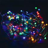 LYYT 120 LED battery topiary ball light string glowing in multicoloured red, green, blue, yellow and white tones on black cable against a dark background.